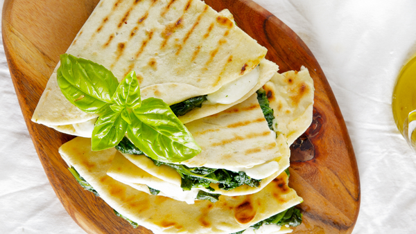 piadina with spinach and mozzarella on a bord